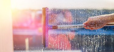 Window Cleaning Brush. Large Window In A Multi-storey Building, Window cleaning in high-rise buildings, houses with a brush. Window cleaning brush. Large window in a multi-storey building, cleaning service. Dust removal and glass washing.