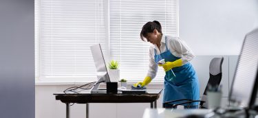 Janitor Cleaning Office Desk. Hygiene Cleaner Service Janitor Cleaning Office Desk. Hygiene Cleaner Service